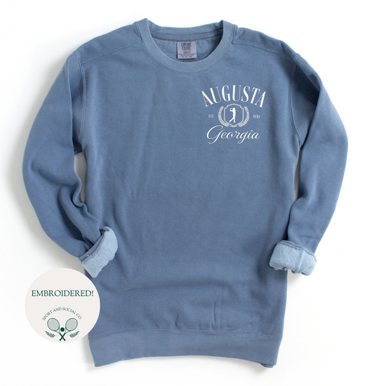 Augusta Georgia embroidered Comfort Colors crewneck sweatshirt with vintage retro golf-inspired design. White embroidery on the left chest pocket area, 4 inches wide, on a soft, garment-dyed pullover.