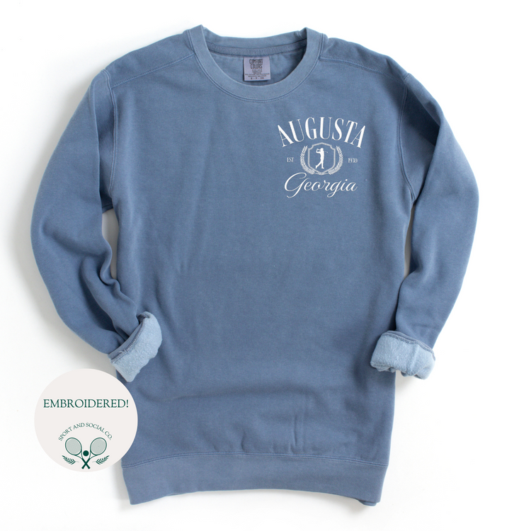 Augusta Georgia embroidered Comfort Colors crewneck sweatshirt with vintage retro golf-inspired design. White embroidery on the left chest pocket area, 4 inches wide, on a soft, garment-dyed pullover.