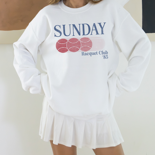 Sunday Racquet Club '85 lightweight cotton crewneck with a vintage retro 80s vibe, featuring bold nostalgic typography on soft cotton fabric.