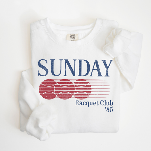 Sunday Racquet Club '85 lightweight cotton crewneck with a vintage retro 80s vibe, featuring bold nostalgic typography on soft cotton fabric.