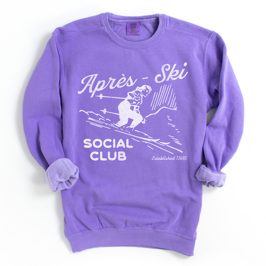 Après Ski Social Club Comfort Colors crewneck sweatshirt featuring a female skier design with vintage retro 80s throwback vibes and a faded grunge look, ideal for bachelorette parties.