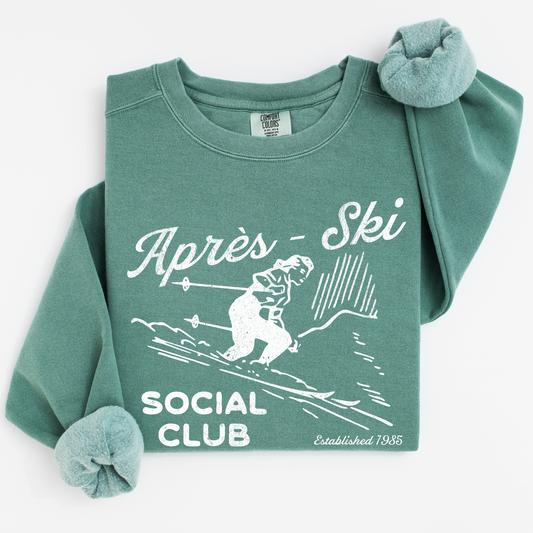 Après Ski Social Club Comfort Colors crewneck sweatshirt featuring a female skier design with vintage retro 80s throwback vibes and a faded grunge look, ideal for bachelorette parties.