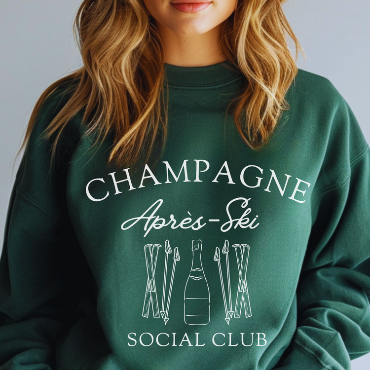 Midweight fleece crewneck sweatshirt with "Champagne Après Ski Social Club" vintage design, perfect for après-ski gatherings and cozy winter wear.