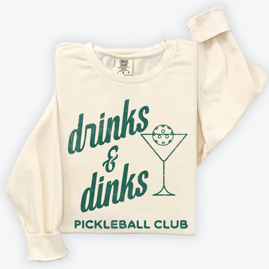 Lightweight cotton crewneck sweatshirt with "Drinks & Dinks Pickleball Club" design in vintage retro sporty style, perfect for casual wear and pickleball games.