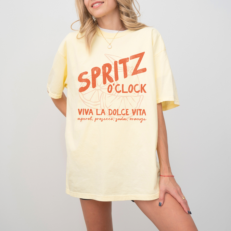 Comfort Colors short sleeve t-shirt with "Spritz O’Clock" in a faded, vintage retro style, perfect for Aperol and Campari lovers and casual, sunny afternoons.