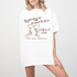 Unisex Comfort Colors short sleeve T-shirt with boho-style Espresso Martini print. Features retro martini glasses adorned with bows, in a faded vintage-inspired design on soft cotton fabric.