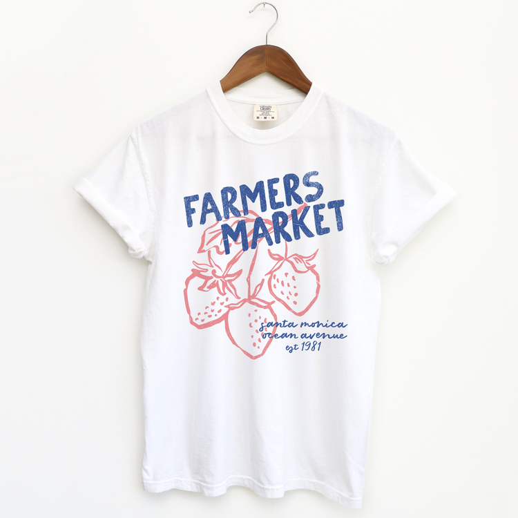 Comfort Colors short sleeve t-shirt with "Santa Monica Farmers Market" in vintage retro style, featuring boho strawberries for a California-inspired, relaxed market look.