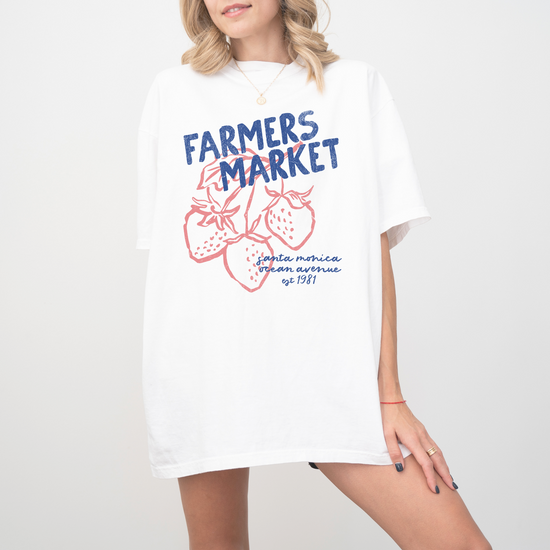 Comfort Colors short sleeve t-shirt with "Santa Monica Farmers Market" in vintage retro style, featuring boho strawberries for a California-inspired, relaxed market look.