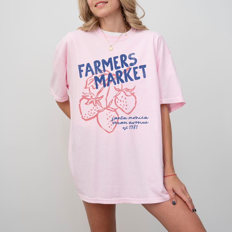 Comfort Colors short sleeve t-shirt with "Santa Monica Farmers Market" in vintage retro style, featuring boho strawberries for a California-inspired, relaxed market look.