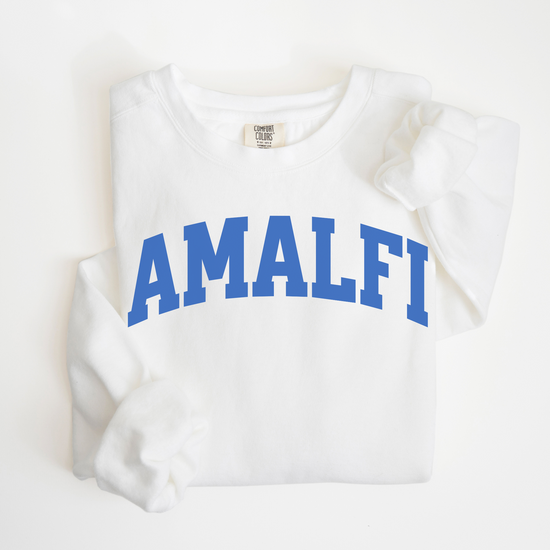 Flatlay image of a lightweight Comfort Colors sweatshirt in soft cotton with 'Amalfi' printed in a sporty, university-style font across the chest. The relaxed, casual fit and vintage-inspired design give the sweatshirt a cozy, well-loved look