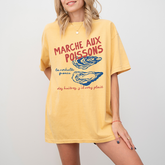 Comfort Colors short sleeve t-shirt with "Marché de Poisson" in a faded, vintage retro boho style, featuring oyster graphics for a French market-inspired look.