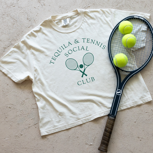 Women's boxy Comfort Colors tee with 'Tequila and Tennis Social Club' print. Vintage athletic aesthetic, relaxed fit, soft fabric. Perfect for casual, sporty style with a playful twist.