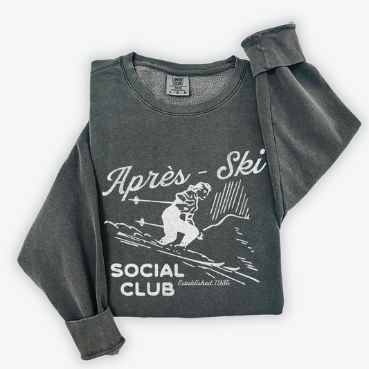 Lightweight crewneck sweatshirt with faded grunge look, vintage graphic of a woman skier, designed with retro après-ski style