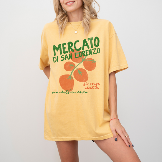 A Comfort Colors short sleeve t-shirt with "Mercato di San Lorenzo, Firenze Italia" and an illustration of tomatoes in a grunge, vintage retro style, inspired by Italian market culture.