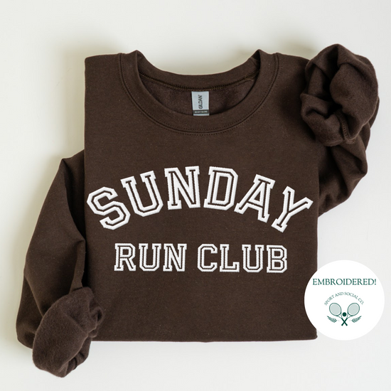 A sweatshirt with "Sunday Run Club" embroidered in bold white stitching across the front, approximately 10 inches wide. The design has a sporty, vintage-inspired look, ideal for casual athleisure wear or workouts.