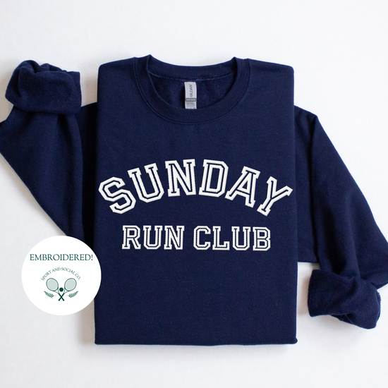 A sweatshirt with "Sunday Run Club" embroidered in bold white stitching across the front, approximately 10 inches wide. The design has a sporty, vintage-inspired look, ideal for casual athleisure wear or workouts.