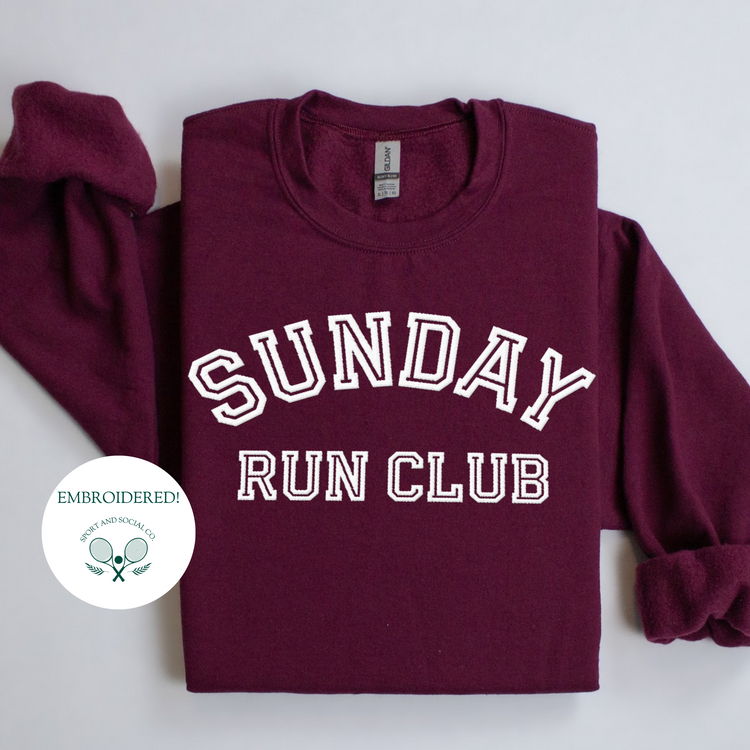 A sweatshirt with "Sunday Run Club" embroidered in bold white stitching across the front, approximately 10 inches wide. The design has a sporty, vintage-inspired look, ideal for casual athleisure wear or workouts.