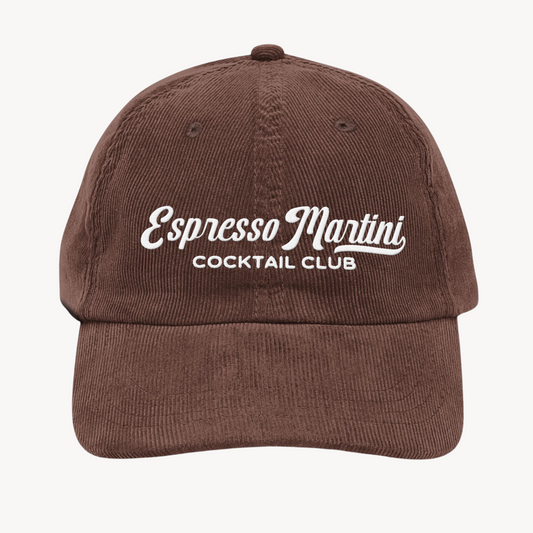 A vintage corduroy cap with "Espresso Martini Cocktail Club" embroidered in a retro-style font, crafted in textured fabric with an adjustable strap.