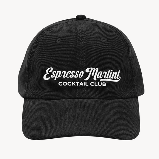 A vintage corduroy cap with "Espresso Martini Cocktail Club" embroidered in a retro-style font, crafted in textured fabric with an adjustable strap.