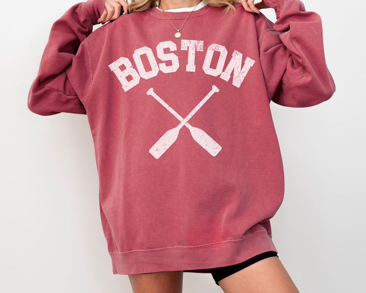 Comfort Colors crewneck sweatshirt with "Boston" lettering and crossed rowing paddles, featuring a vintage faded grunge look, perfect for athleisure and casual wear.