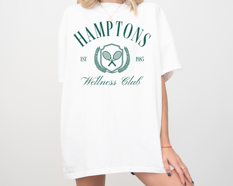 Hamptons Wellness Club short sleeve t-shirt with retro tennis graphics, worn by a model, white color with green print