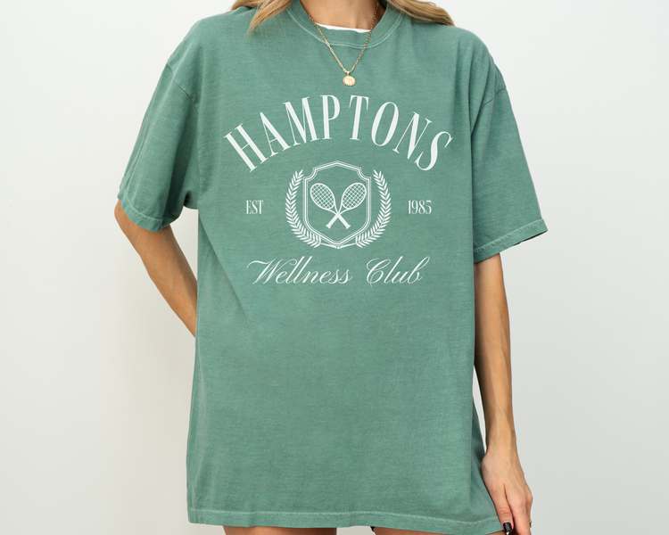 Hamptons Wellness Club short sleeve t-shirt with retro tennis graphics, worn by a model, green shirt with white print