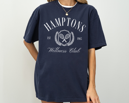 Hamptons Wellness Club short sleeve t-shirt with retro tennis graphics, worn by a model, navy shirt with white print