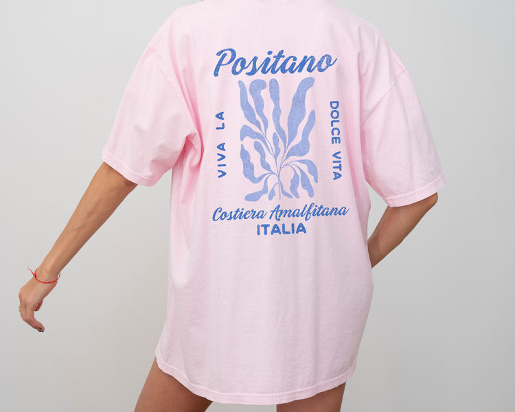 Comfort Colors short sleeve t-shirt featuring a whimsical coastal design on the back, "Viva la Dolce Vita" text, and a faded vintage grunge look in coastal blue, ideal for summer and travel vibes.